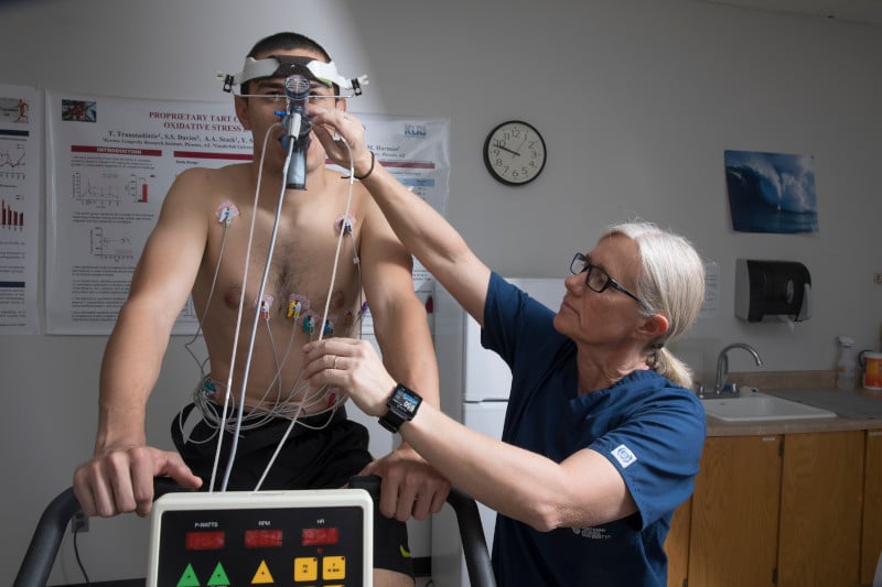 Biology professor Tinna Traustadottir hooks a test subject up to wires to measure vital signs