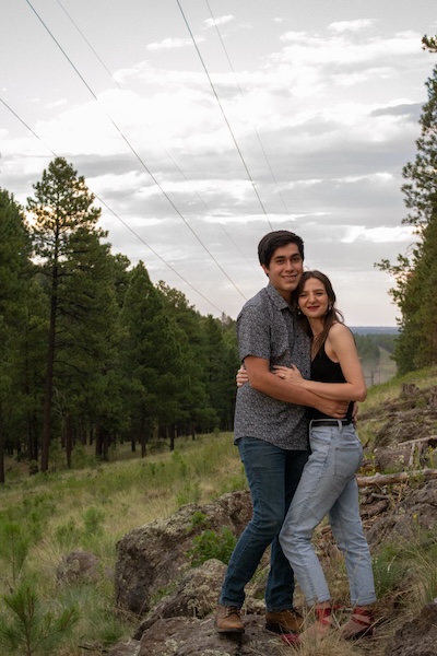 Daniel Kennedy posing with a young woman in the forest in Flagstaff