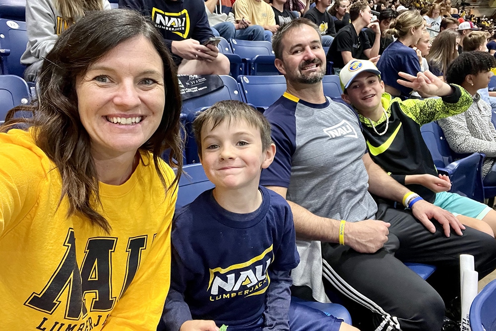Annie Watson and her husband and two boys at an NAU football game