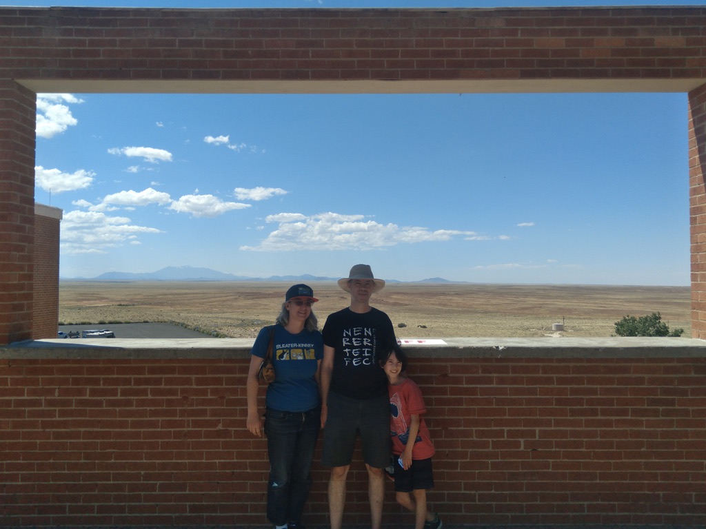 Attrep, Wallace and their son at Meteor Crater with the San Francisco Peaks in background, 2023