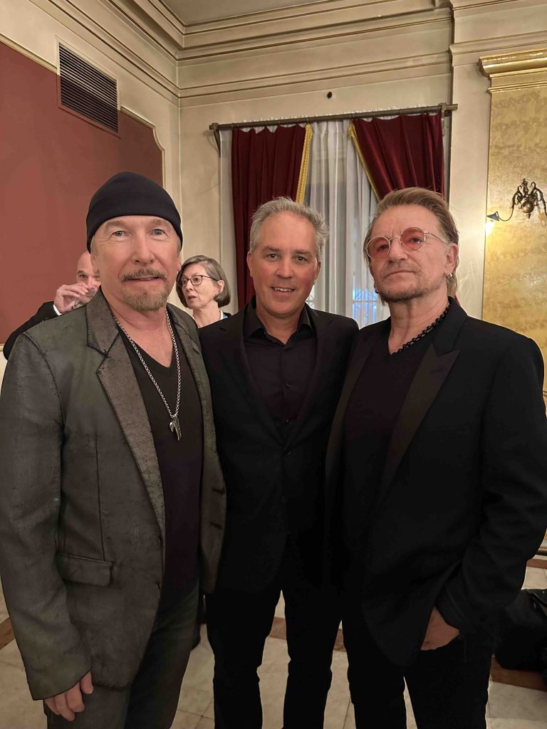 Bill Carter posing with Bono and The Edge from U2