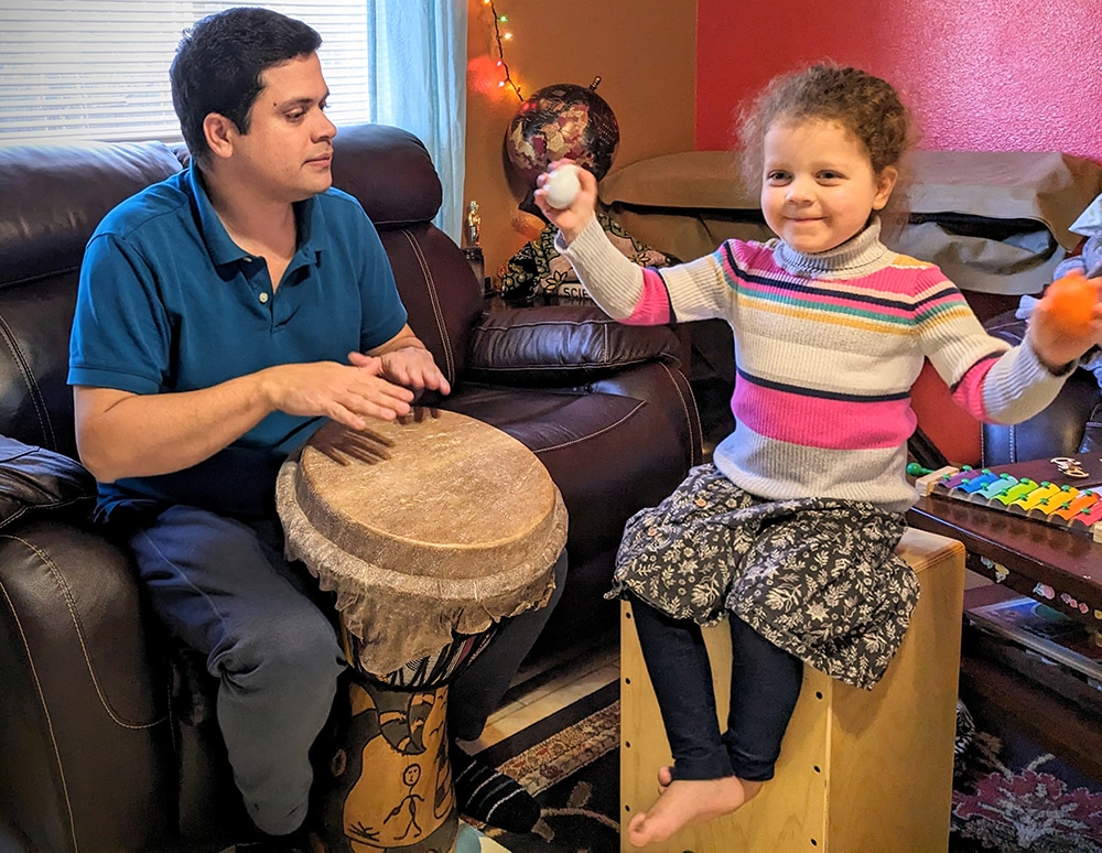 Mallik plays the djembe with his daughter.