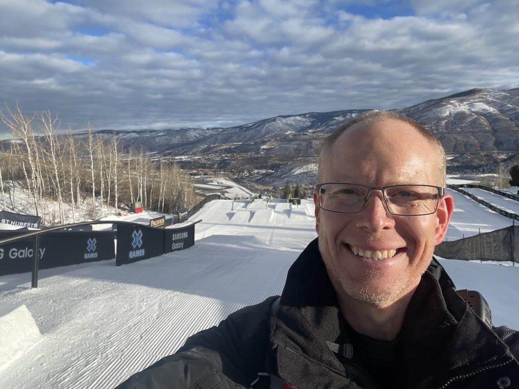 Ian McLeod posing at the top of a slopestyle ski course at the Winter X Games in Aspen, Colorado