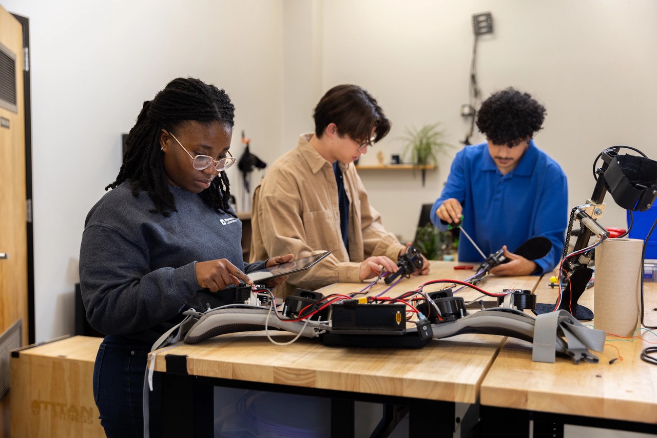 Students in the biomechatronics lab work on a piece of wearable robotics
