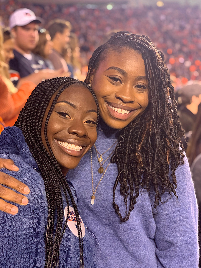 Kiera Butler and her sister hugging at a sporting event.
