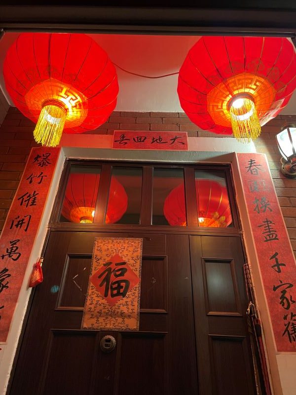 a door decorated with red lanterns and scrolls for Lunar New Year
