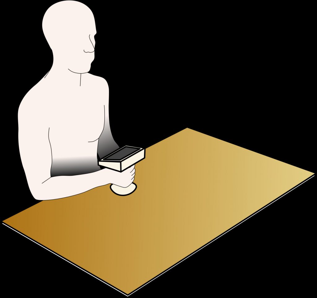 rendering of a person sitting at a table holding a small device with a screen on top
