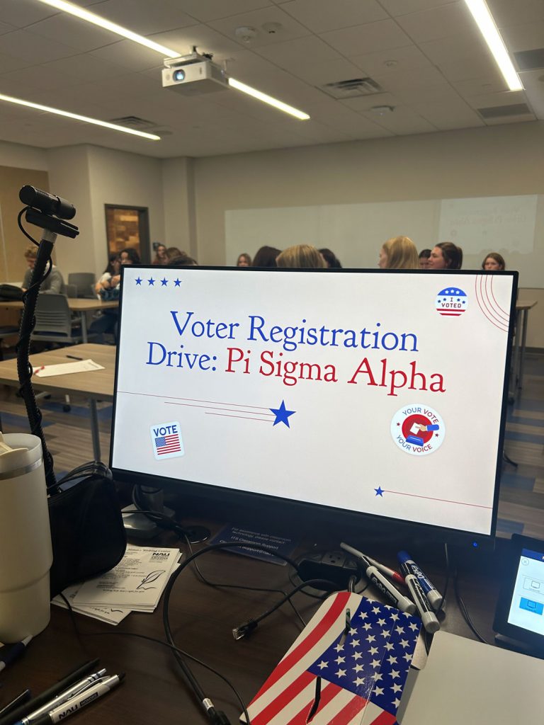 computer monitor that reads Voter Registration Drive: Pi Sigma Alpha