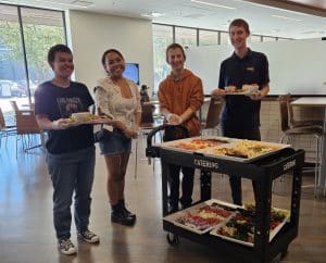 Students recovering trays of food from a campus dining location.