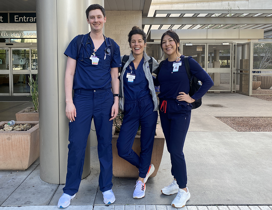 Claudia Iglesias-Buck and two other nurses in scrubs standing outside a hospital.