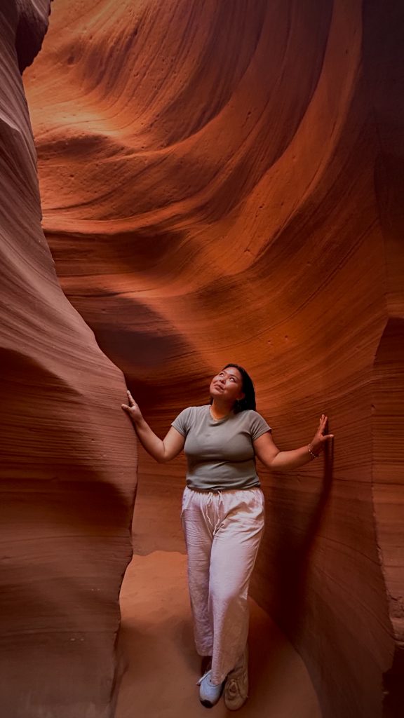 Mariessa Fowler standing in a red rock slot canyon