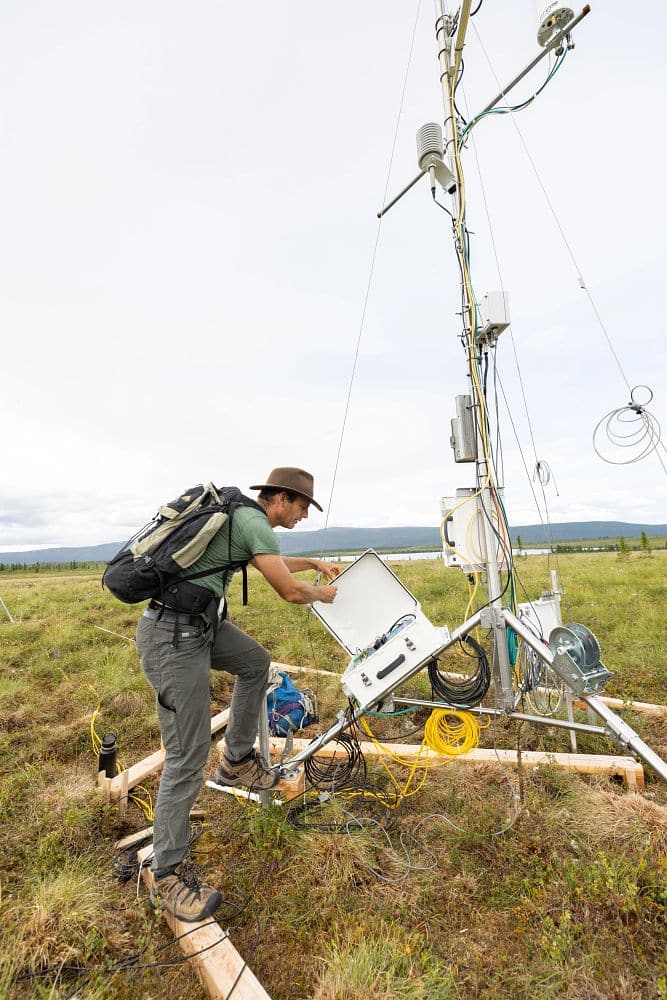 Ted Schuur working on a tower in the Alaskan permafrost.