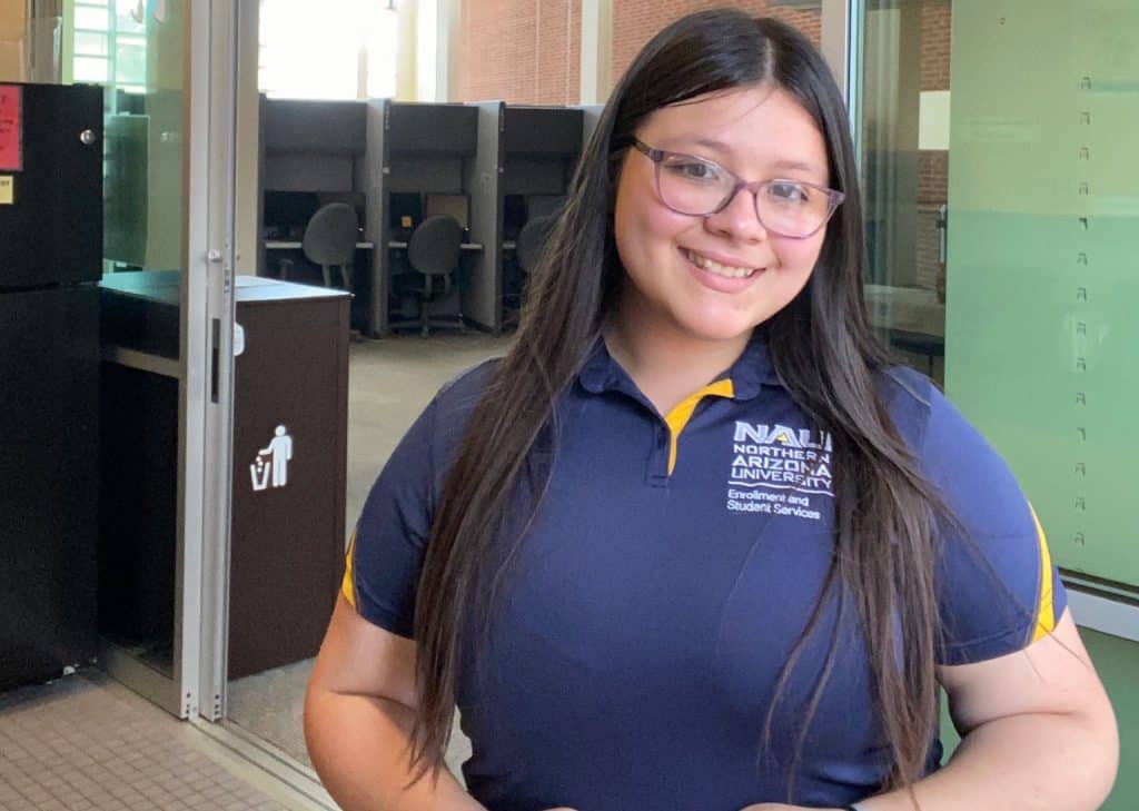 Kimberly Higuera wearing an NAU Enrollment and Student Services polo shirt