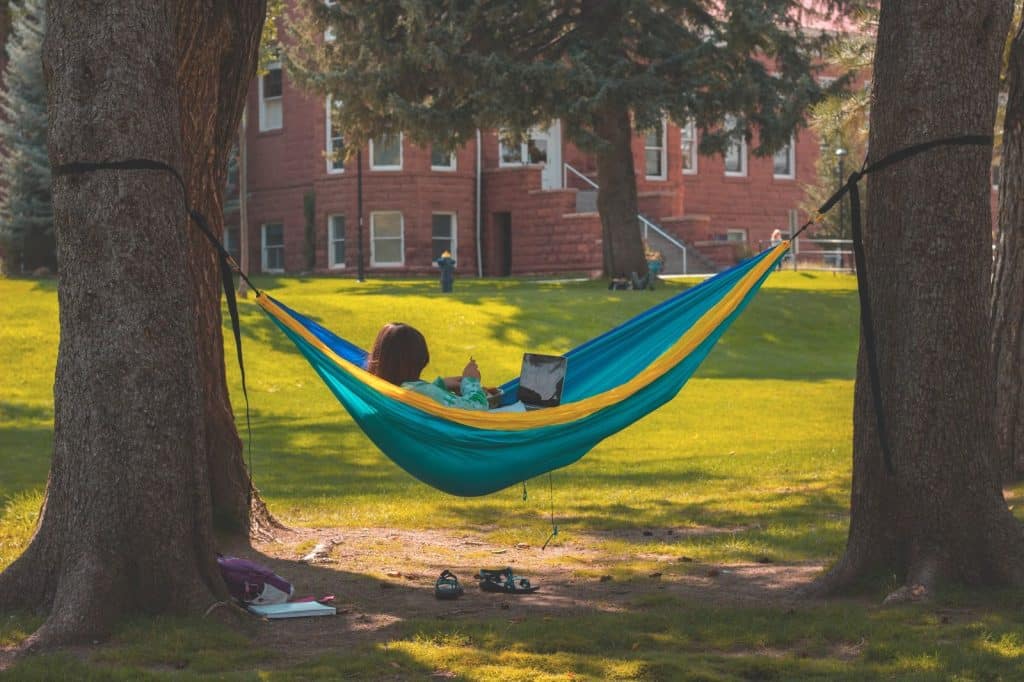 Woman reading in a hammock on the NAU campus