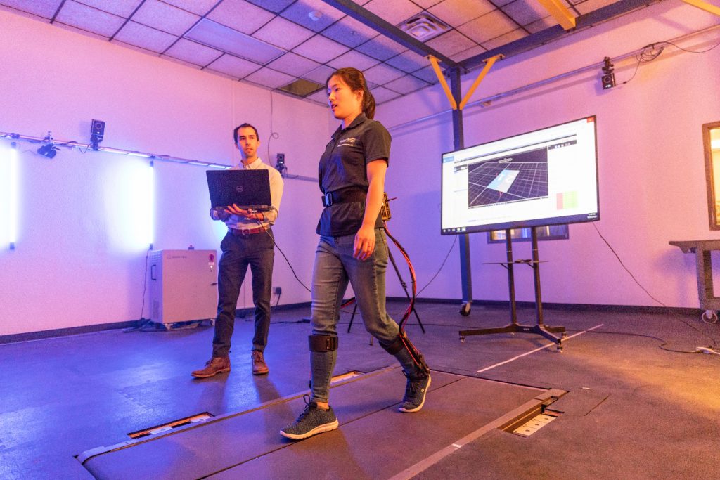 An NAU researcher tests a wearable robotic exoskeleton with associate mechanical engineering professor Zach Lerner in NAU's Biomechatronics Lab.