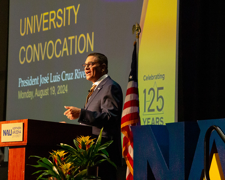 President Cruz Rivera speaks from a podium at convocation.