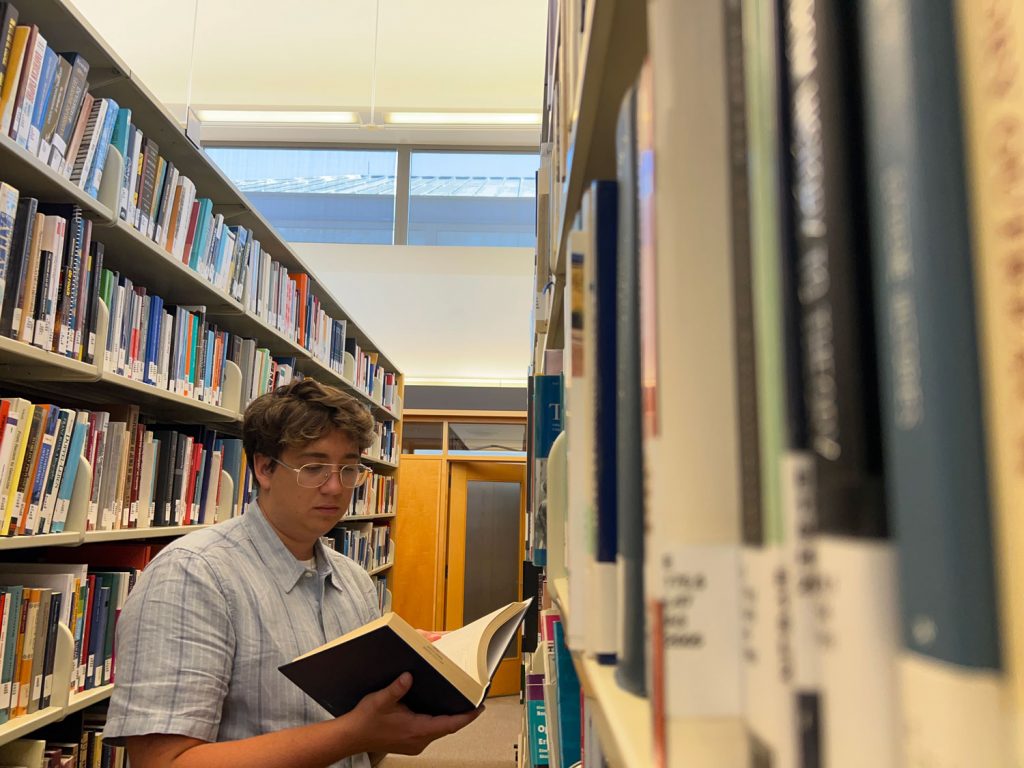 Henry Petterson reading a book inside the library at the National Holocaust Memorial Museum