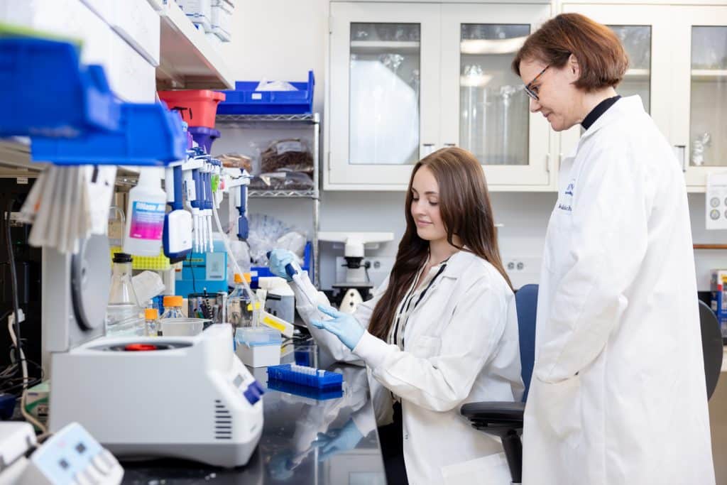 Avery Carter working in a lab with Rita Sattler at the Barrow Neurological Institute