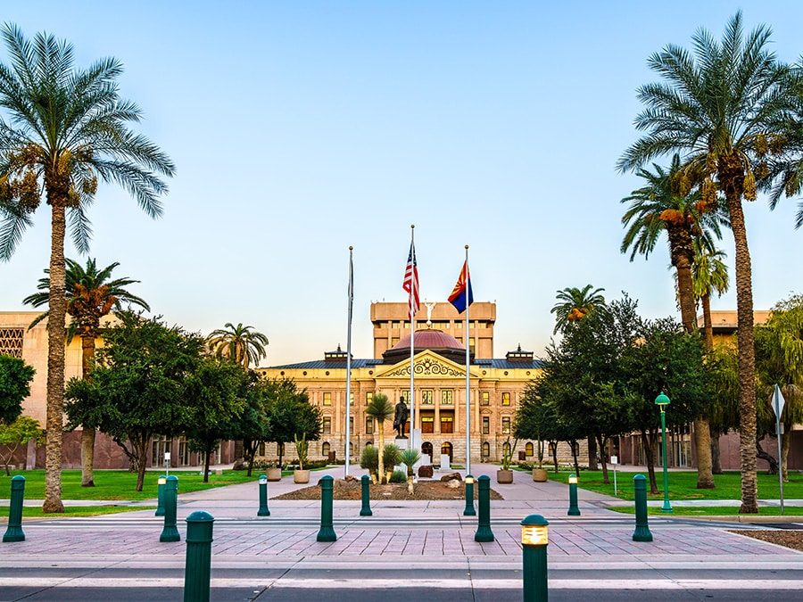 The Arizona Capitol building surrounded by palm trees