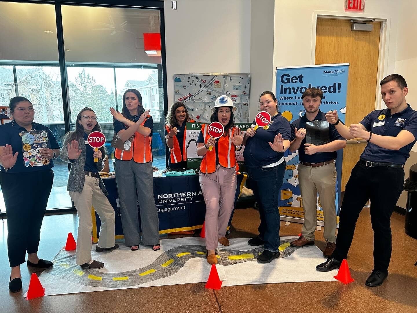 The Office of Leadership and Engagement team with traffic cones and vests and stop signs