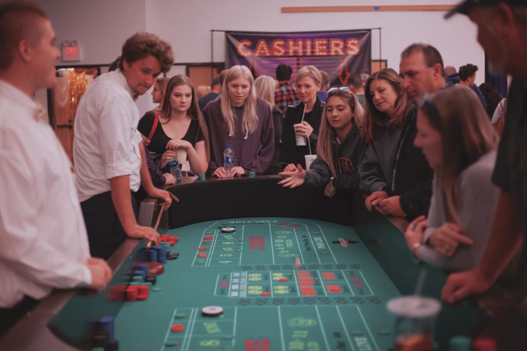 people standing around a craps table