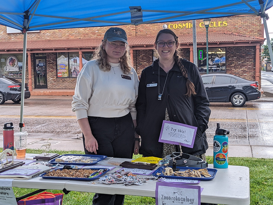 Chrissina Burke and her student working a booth at science festival