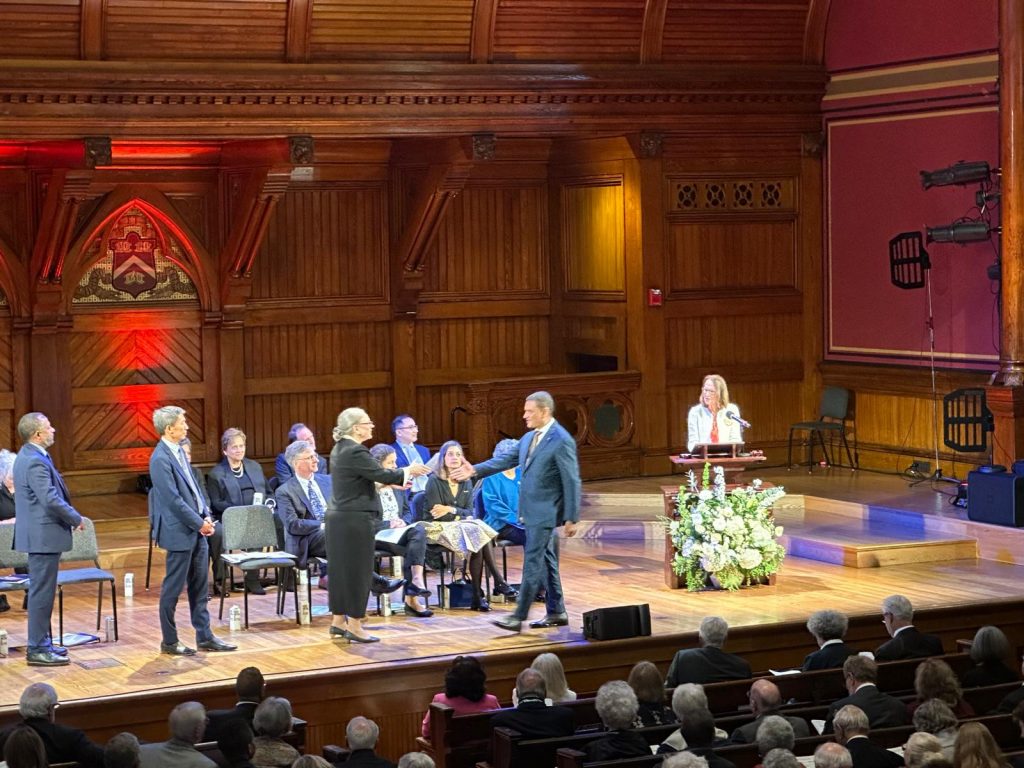 President Cruz Rivera crosses the stage at the induction ceremony.