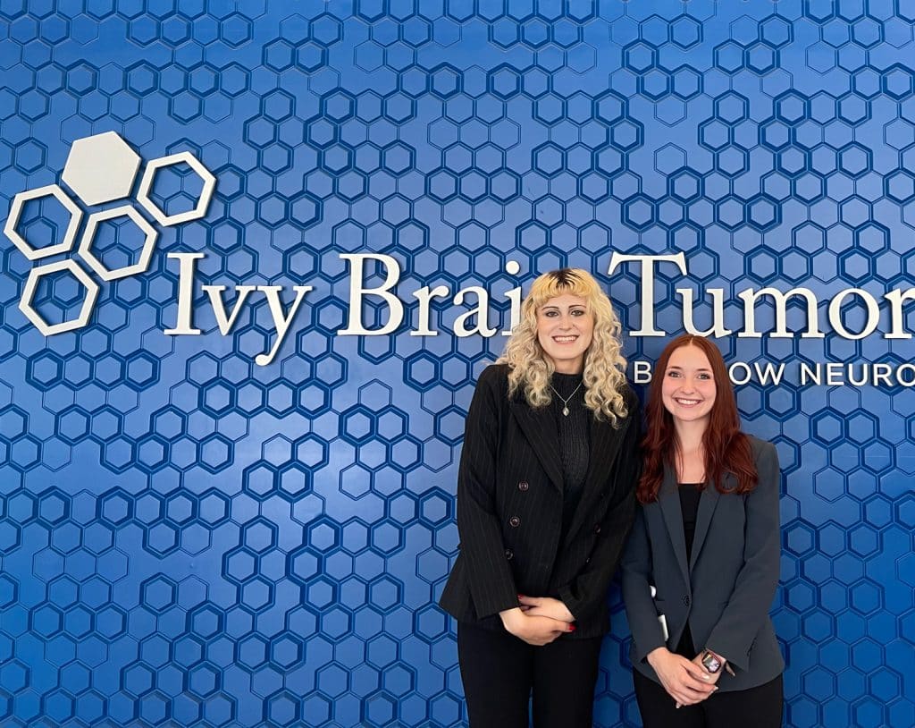 Alexandra Wicker and Sophia Justice standing in front of the Ivy Brain Tumor Center at the Barrow Neurological Institute