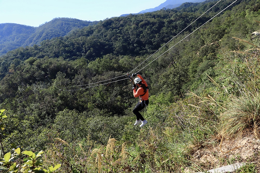 Jozie Ashleson zipling over a forest