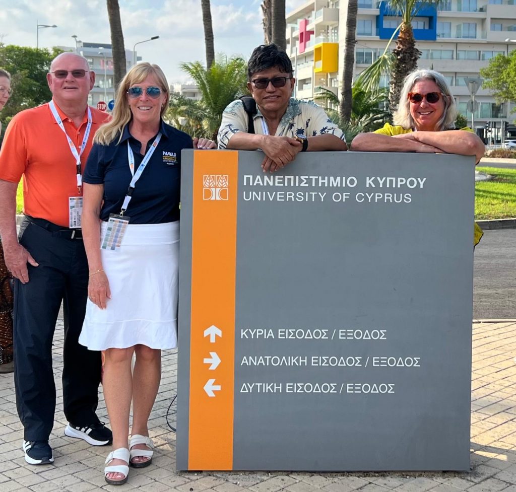 ISSPP researchers posing in front of a sign in Cyprus