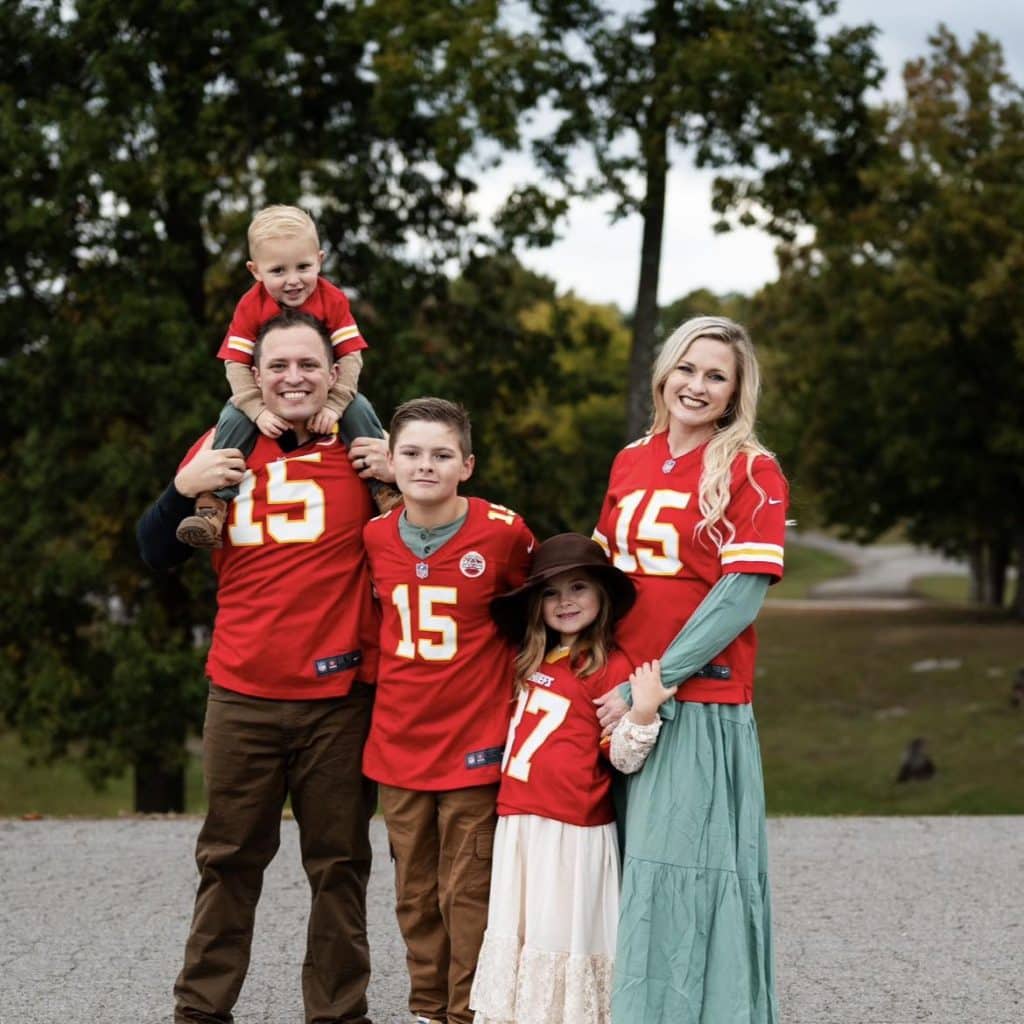 Joshua Kandybowicz posing with his family in Arizona Cardinals jerseys