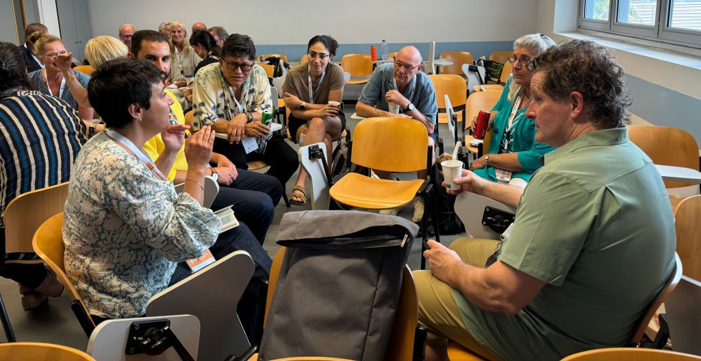 school principals talking with one another in a circle at a conference