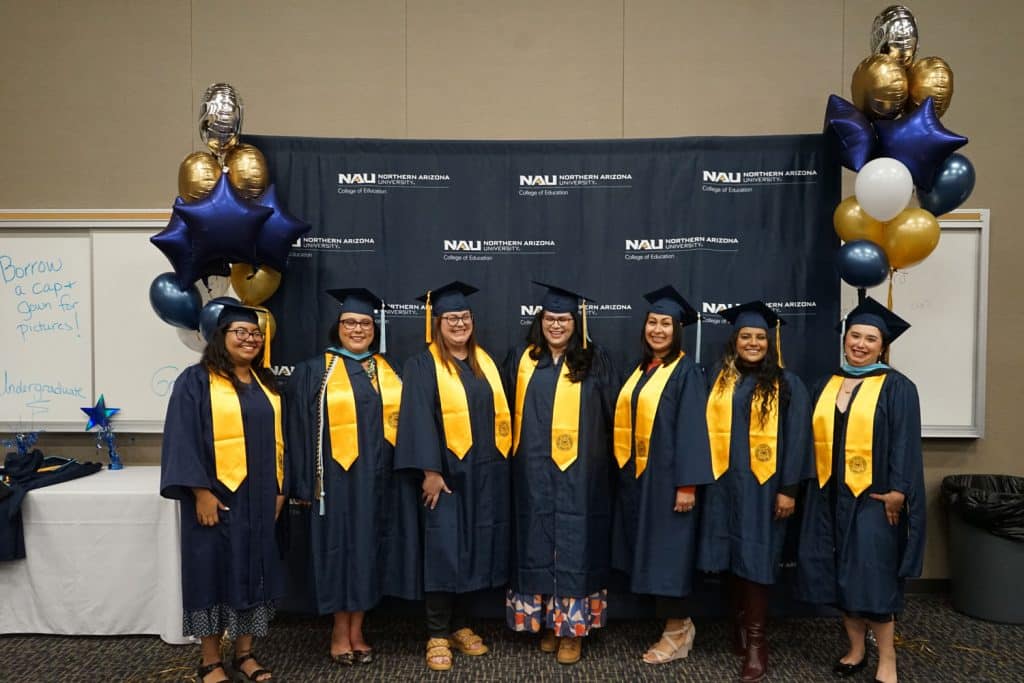 NAU graduates posing for a photo