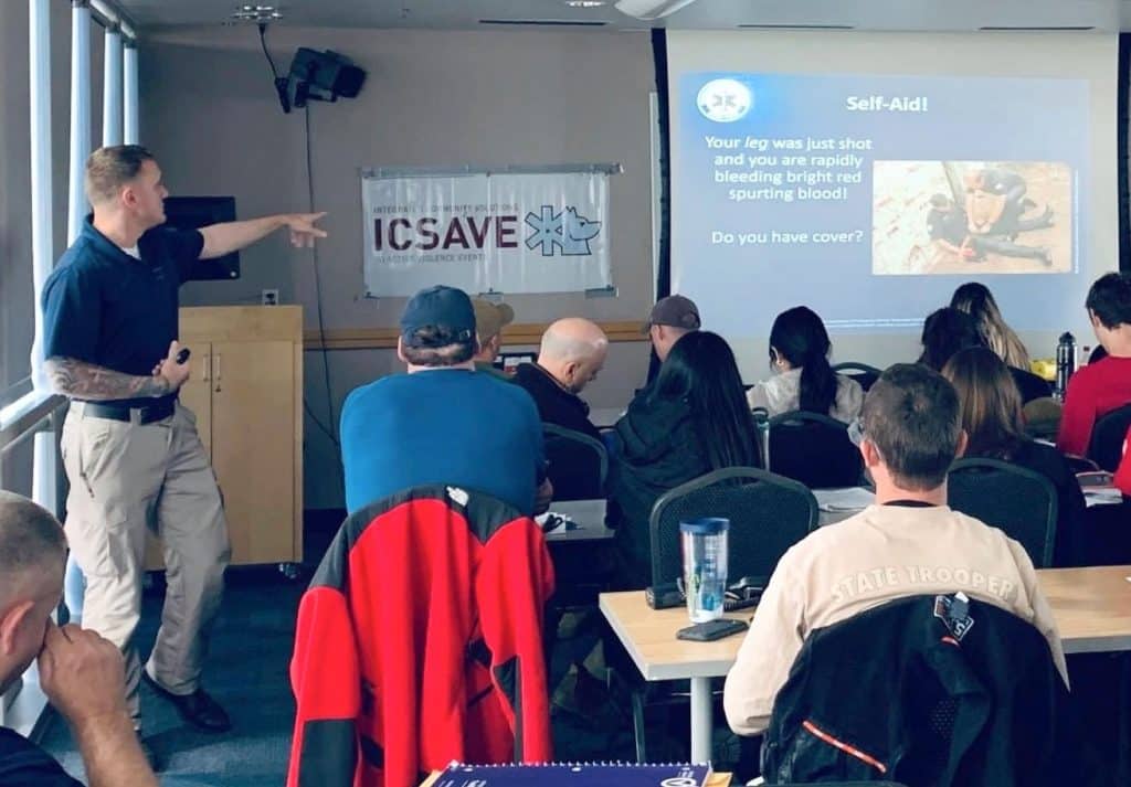 man teaching an emergency medicine course on a projector