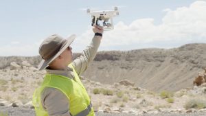 man holding drone at Meteor Crater