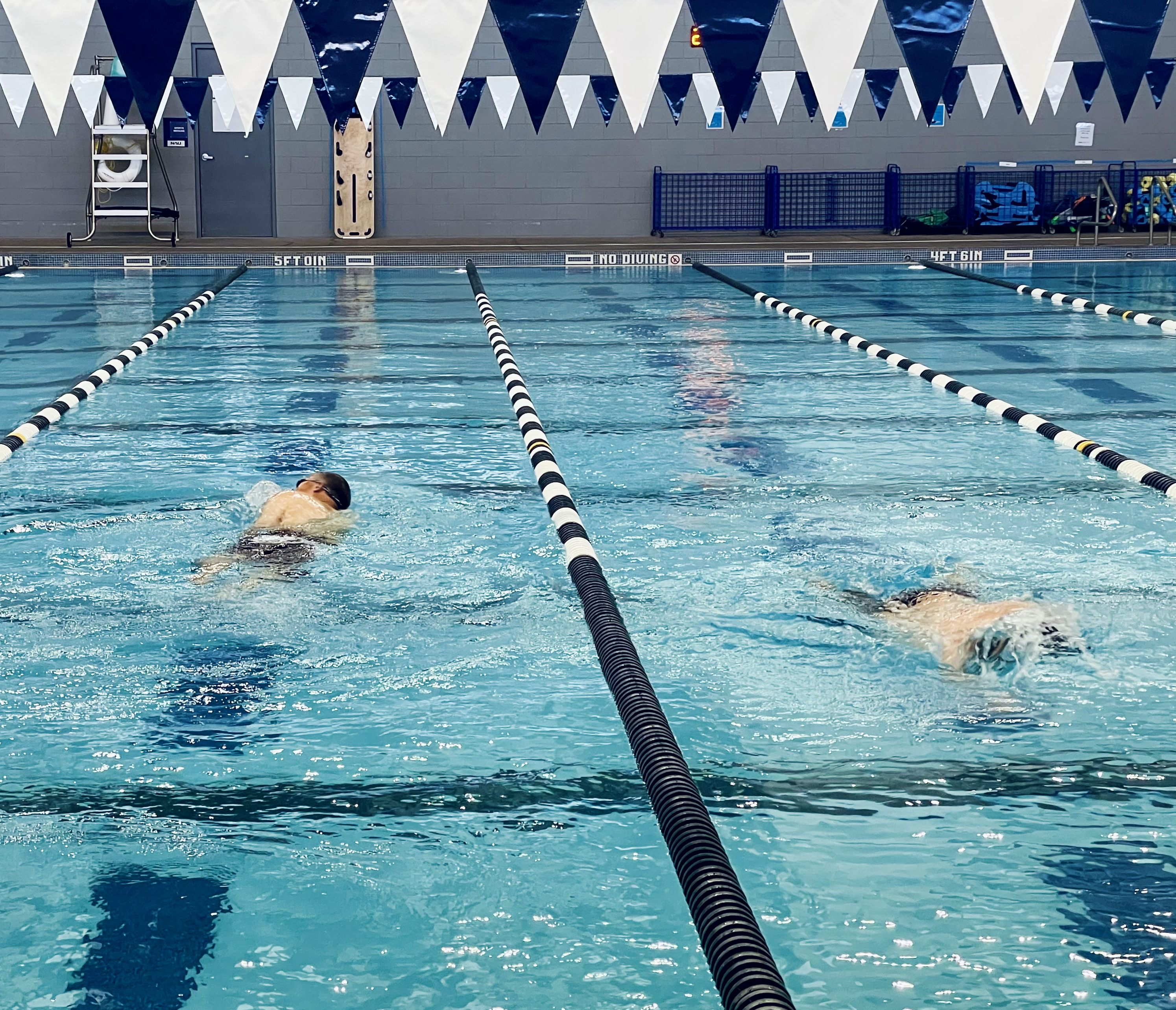 Two people swim in lanes