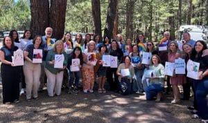 Group of people holding signs in the forest