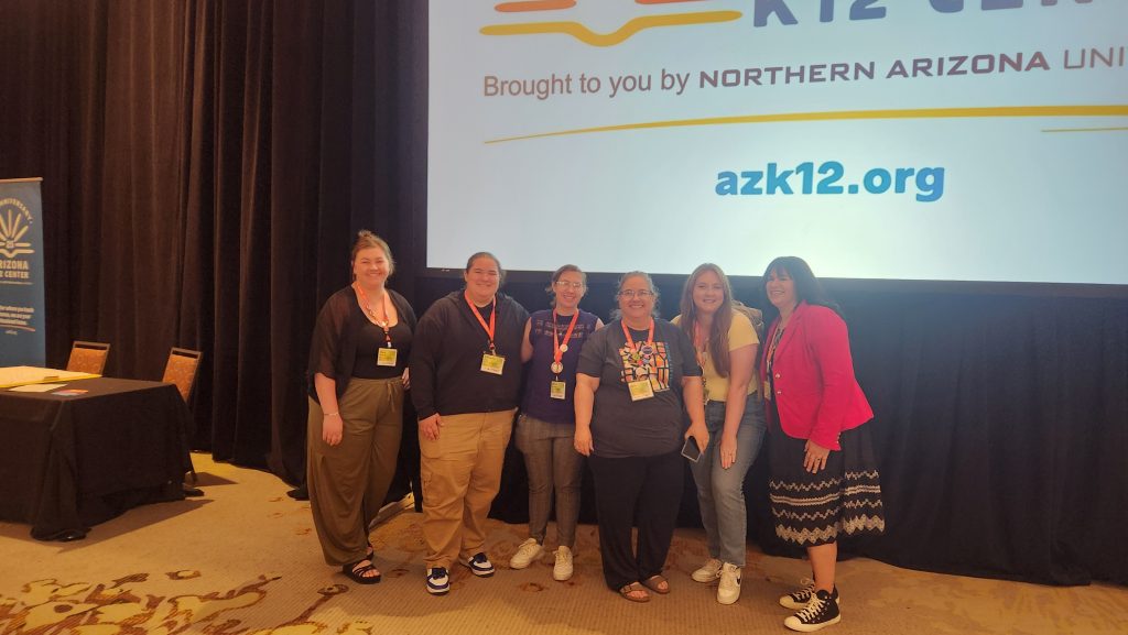 Beth Douthitt posing with teacher mentees at an AZK12 event