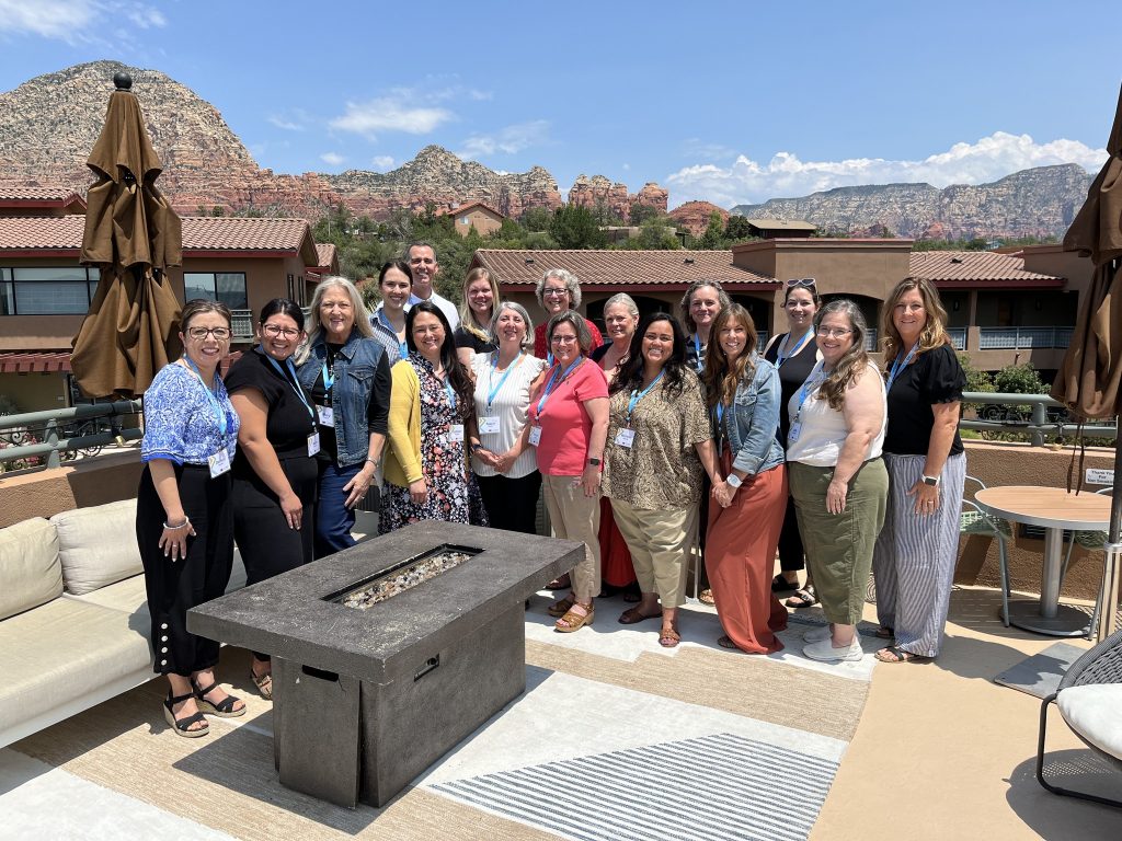Mentors and mentees in the ATA program pose on a rooftop in Sedona with Joshua Meibos
