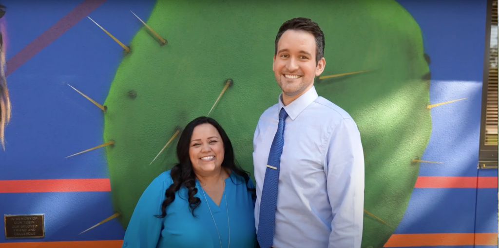 ATA mentor Michelle Doherty posing in front of a cactus mural with Rodell Endres, a new teacher