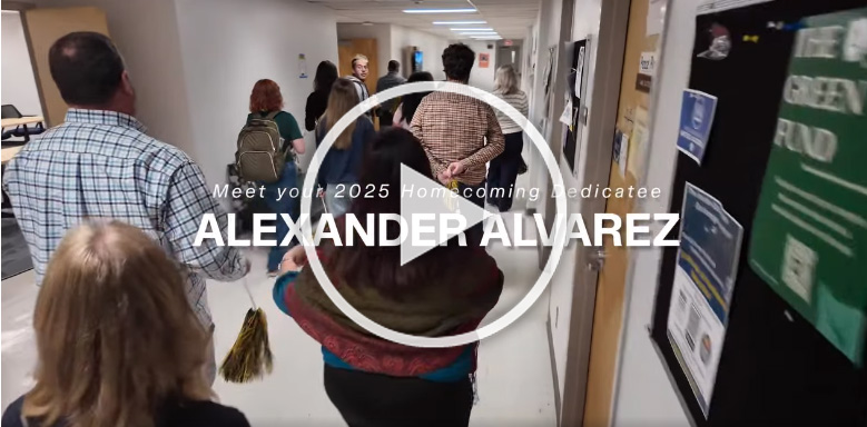 Video still of people walking down hallway