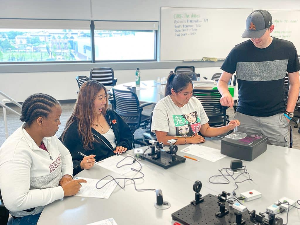 Four students learn about quantum.