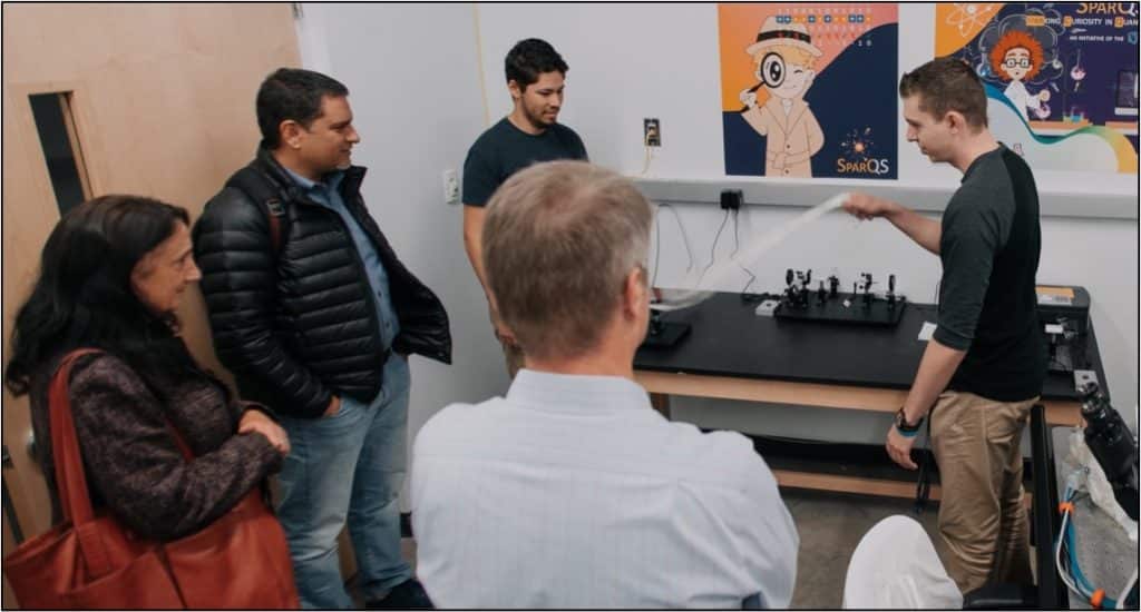 Jason Wilder, President Cruz Rivera and Karen Pugliesi learn about quantum science.