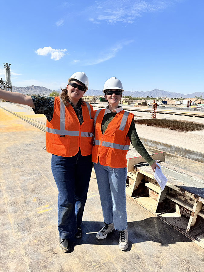 Payton Correia and Isabella Velasco in safety vests and hard hats