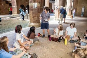 Students inside a museum in Italy hearing a lecture