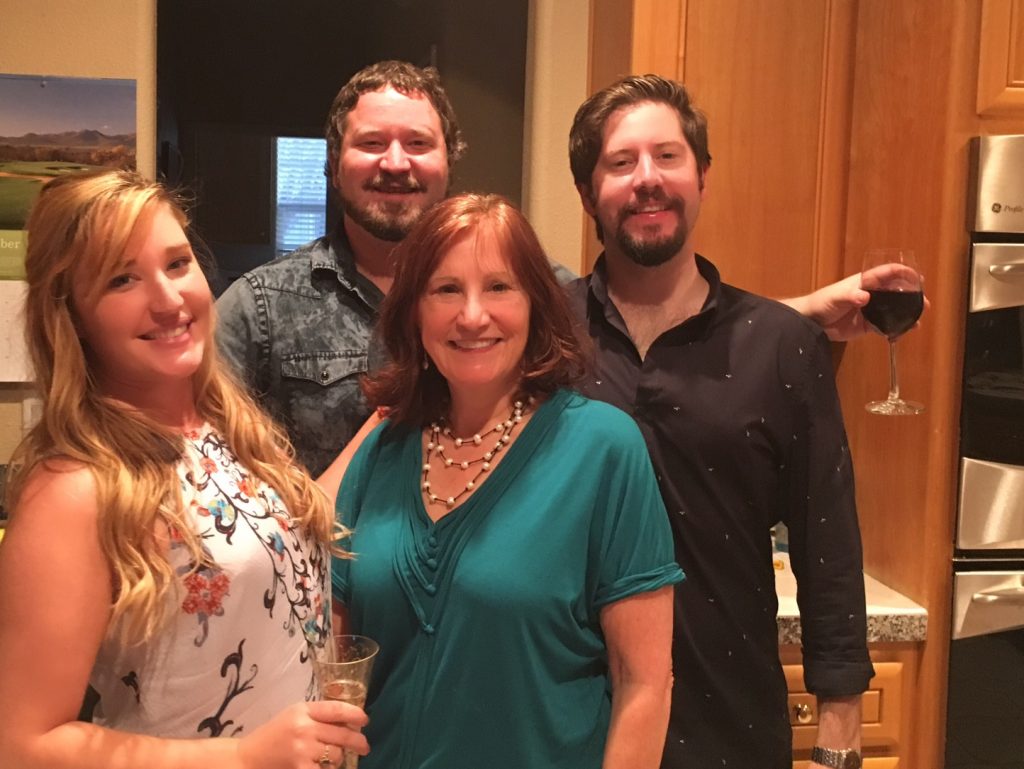 Woman and three kids posing in a kitchen