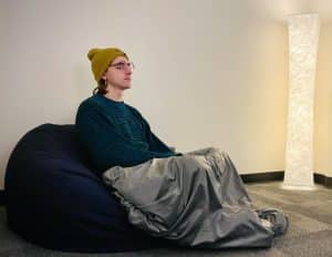 Individual sitting inside the sensory room at NAU