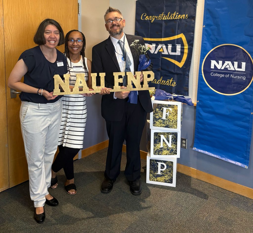 Adrien Gupton posing with FNP colleagues at an NAU event