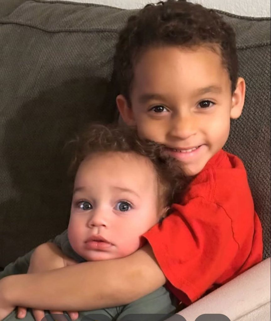 Adrien's two grandchildren hugging each other