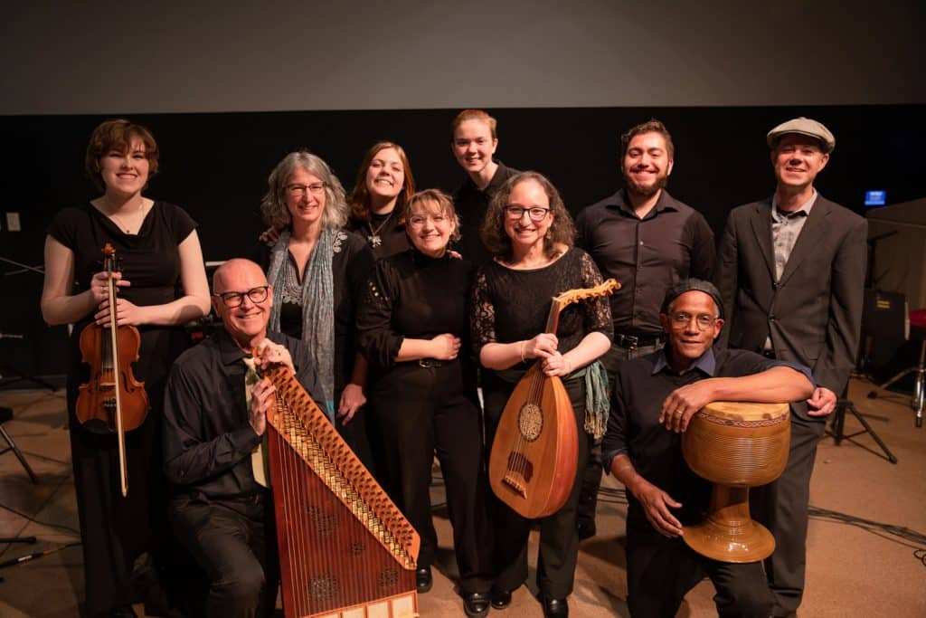 Middle East Ensemble in concert dress and holding instruments